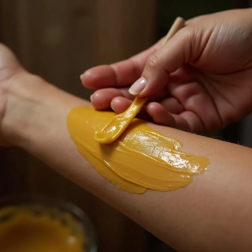 Woman Applying Halawa Wax