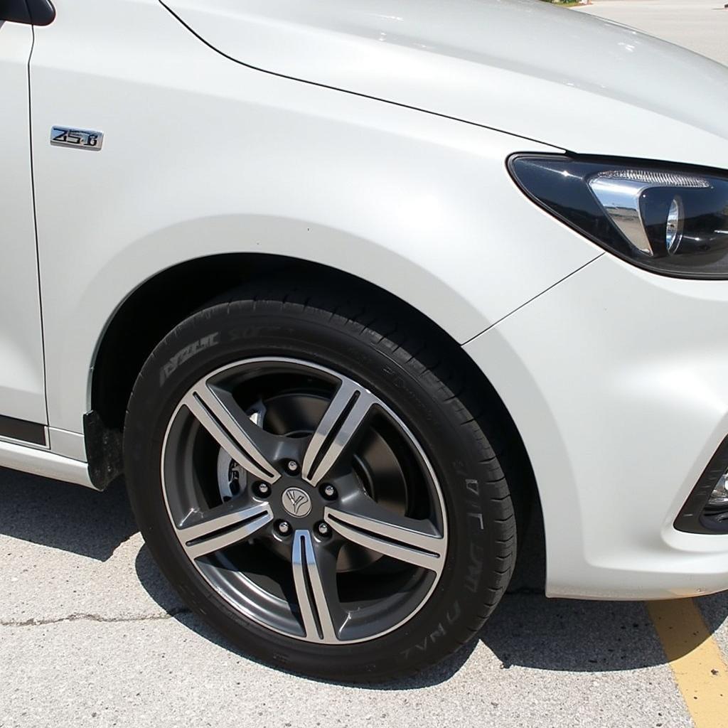 A car with Yokohama Advan dB 185 65R15 tires installed, showcasing the fit and appearance on a vehicle.